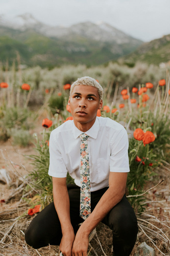 Orange Pansy tie worn with a white shirt and black pants.