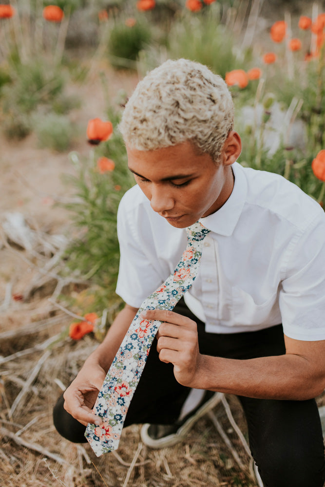 Orange Pansy tie worn with a white shirt and black pants.