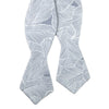 Palm Self Tie Bow Tie. Blue/gray background with white palm leaf pattern over entire tie.
