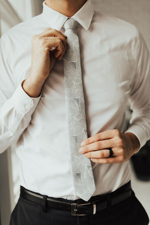 Palm tie worn with white shirt, black belt and black pants.