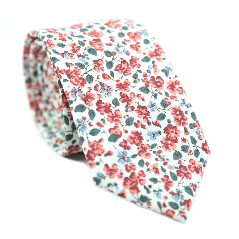Peach Blossom Skinny Tie. White background with small red and dusty blue flowers and small green leaves.