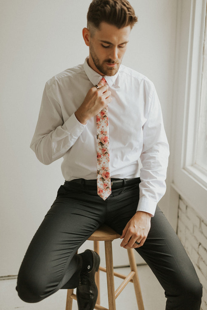 Peony tie worn with a white shirt, black belt and black pants.