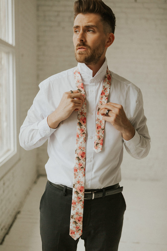 Peony tie worn with a white shirt, black belt and black pants.