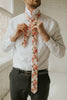 Peony tie worn with a white shirt, black belt and black pants.