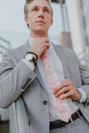 Pink Meadow tie worn with a white shirt, black belt and gray suit.