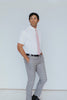 Pink Pansy Tie worn with a white shirt, black belt and gray plaid suit pants.