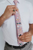 Pink Pansy Tie worn with a white shirt, black belt and gray plaid suit pants.