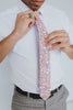 Pink Pansy Tie worn with a white shirt, black belt and gray plaid suit pants.