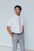 Pink Pansy Tie worn with a white shirt, black belt and gray plaid suit pants.