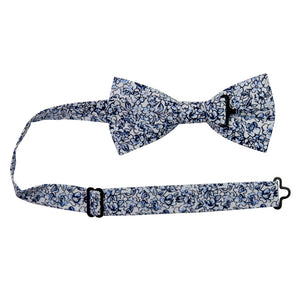 Powder Pre-Tied Bow Tie with adjustable neck strap. White background with small navy and dusty blue flowers and black stems.