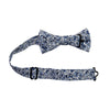 Powder Pre-Tied Bow Tie with adjustable neck strap. White background with small navy and dusty blue flowers and black stems.