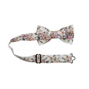 Quicksand Roses Pre-Tied Bow Tie with adjustable neck strap. White background with mauve, peach and blush pink flowers. Sage green leaves and branches throughout.
