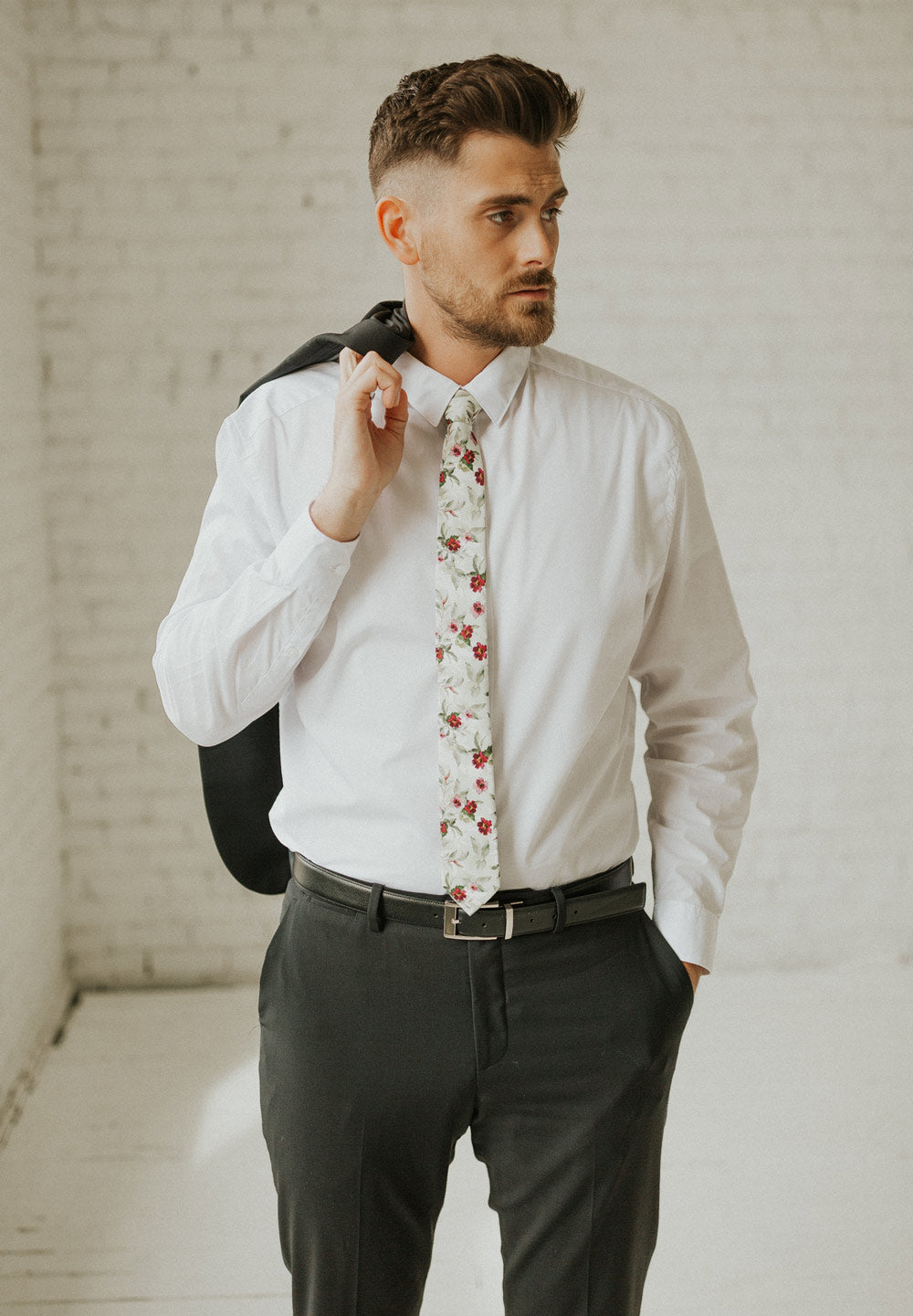 Red Clover tie worn with a white shirt, black belt and black pants.