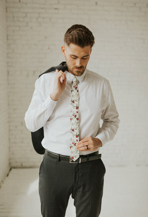 Red Clover tie worn with a white shirt, black belt and black pants.