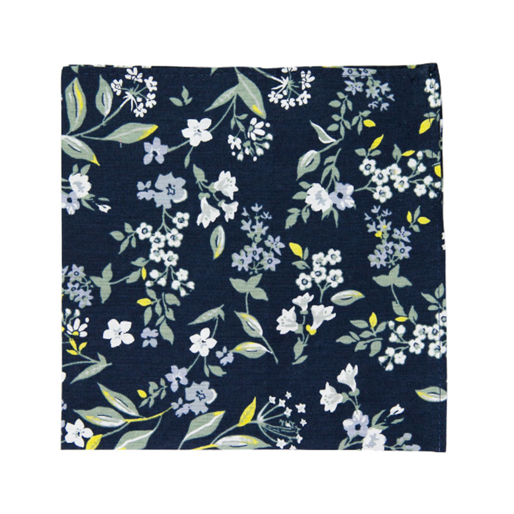 Rio Pocket Square. Navy blue background with white and light blue flowers, green and yellow leaves and stems.