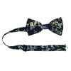 Rio Pre-Tied Bow Tie with adjustable neck strap. Navy blue background with white and light blue flowers, green and yellow leaves and stems.
