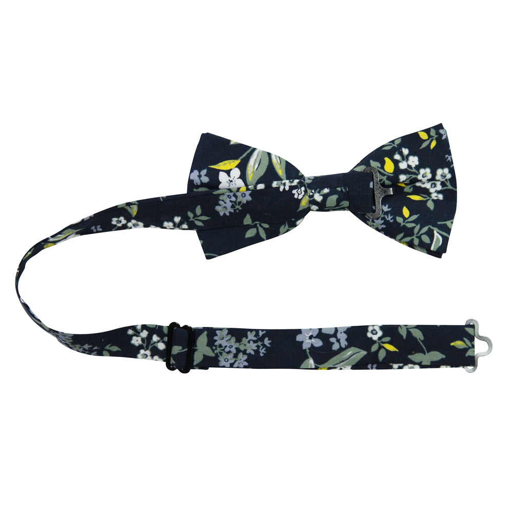 Rio Pre-Tied Bow Tie with adjustable neck strap. Navy blue background with white and light blue flowers, green and yellow leaves and stems.