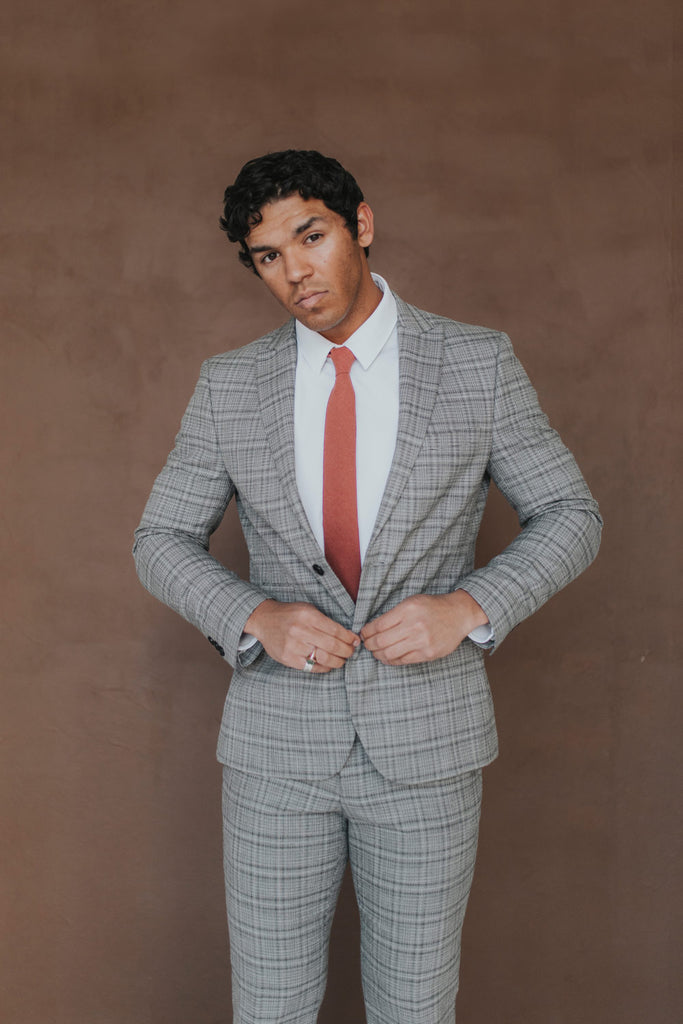 Rust Tie worn with a white shirt, black belt and gray plaid suit.