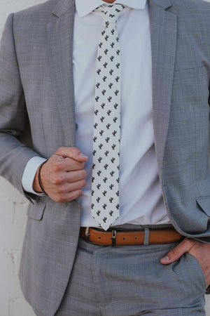Saguaro tie worn with a white shirt, gray suit and brown belt.