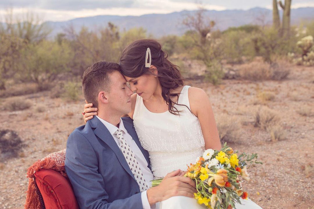 Saguaro tie worn by a groom at a wedding with a white shirt and blue suit jacket.