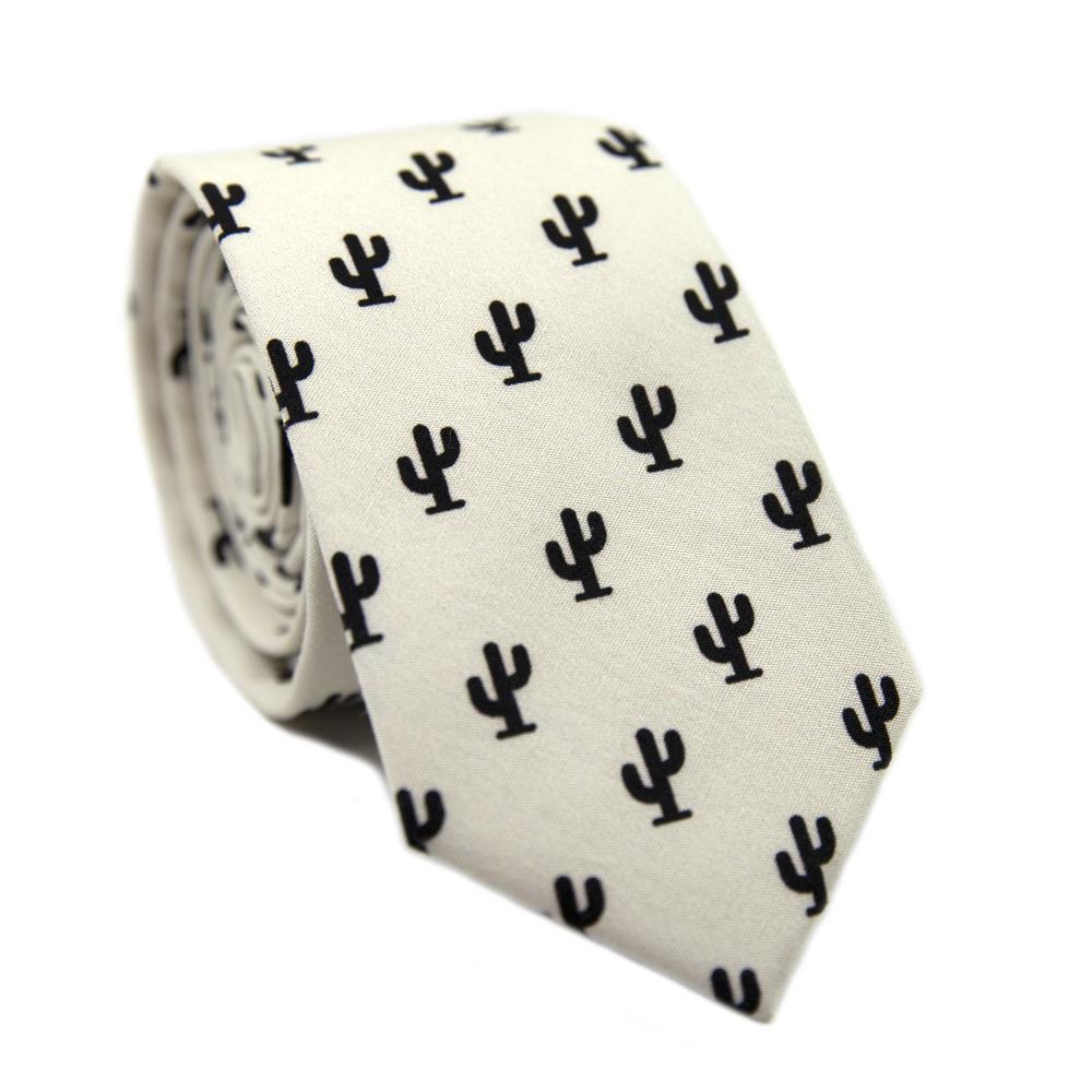 Saguaro Skinny Tie. Cream background with small black cactus images all over the tie.