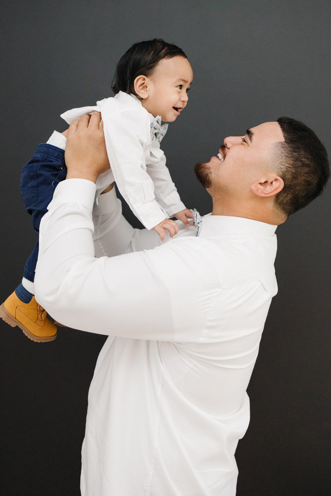 Scorpion Grass pre-tied bow tie worn by a father and son with a white shirt and blue pants.