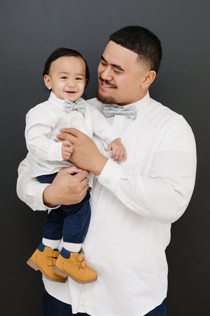 Scorpion Grass pre-tied bow tie worn by a father and son with a white shirt and blue pants.