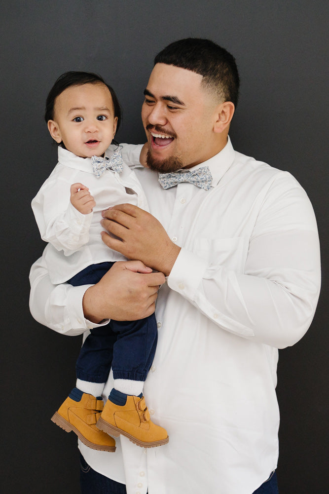 Scorpion Grass pre-tied bow tie worn by a father and son with a white shirt and blue pants.