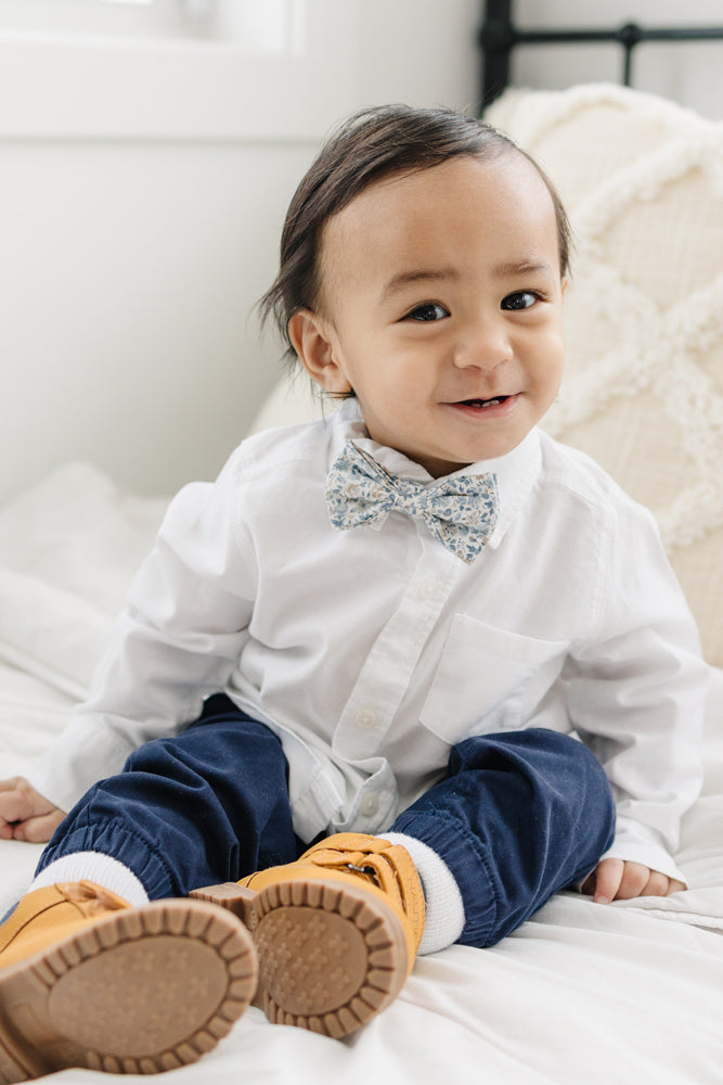Scorpion Grass pre-tied bow tie worn with a white shirt and blue pants, brown boots.
