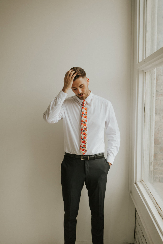 Silent Love tie worn with a white shirt, black belt and black pants.