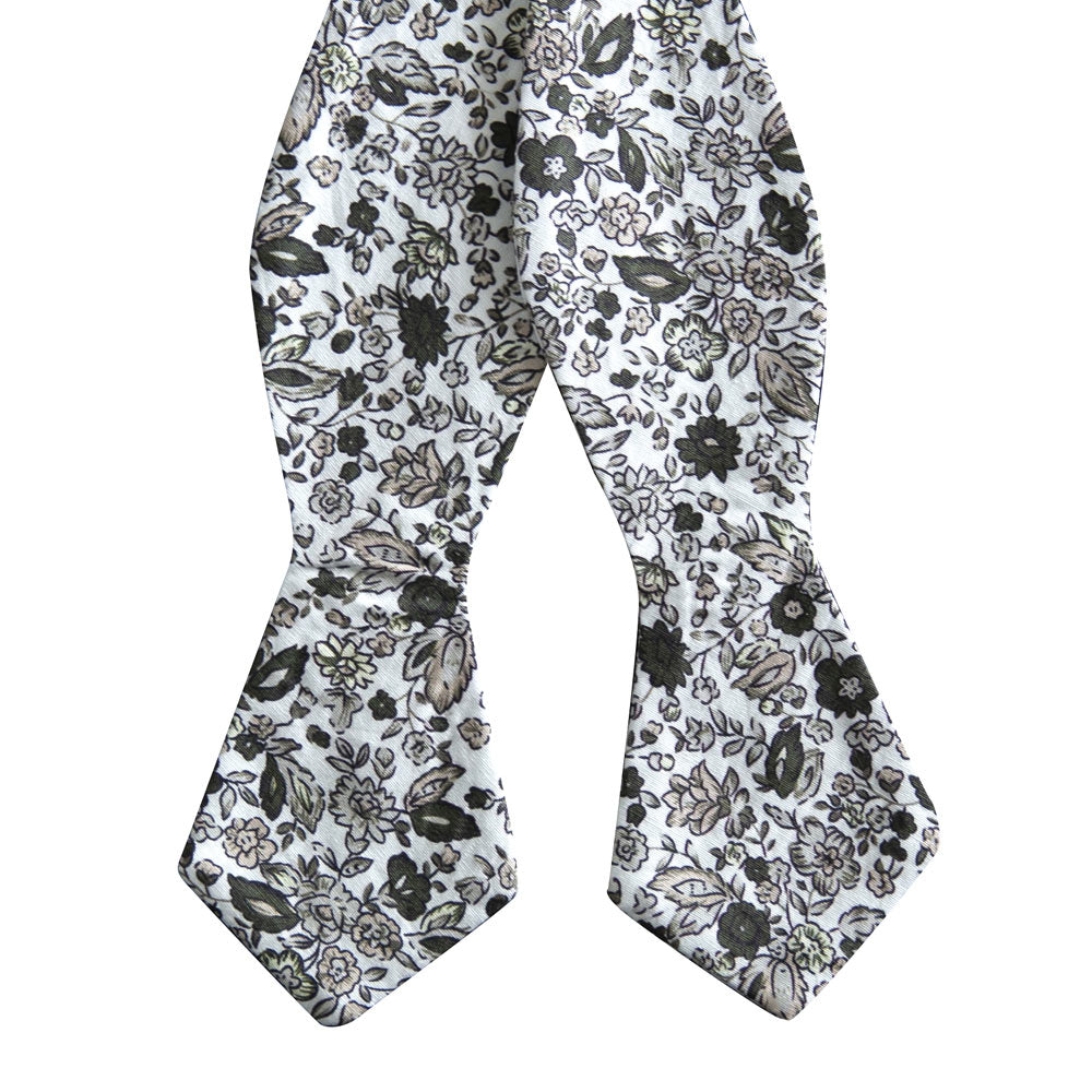 Silhouette Self Tie Bow Tie. White background with gray, black and light tan flowers and leaves.