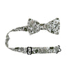 Silhouette Pre-Tied Bow Tie with Adjustable Neck Strap. White background with gray, black and light tan flowers and leaves.