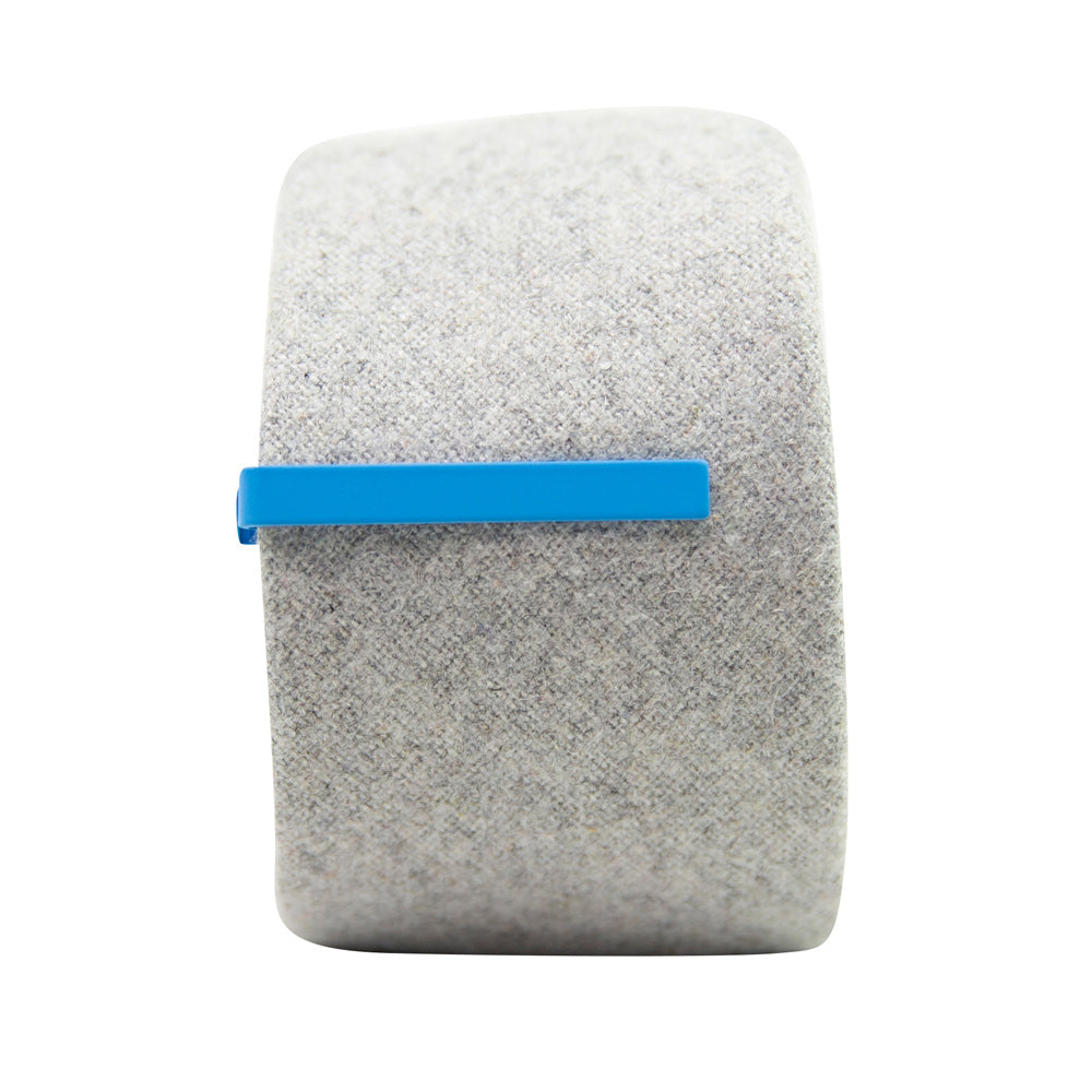 Solid sky blue metal tie bar clipped onto a gray textured wool tie that is rolled up.