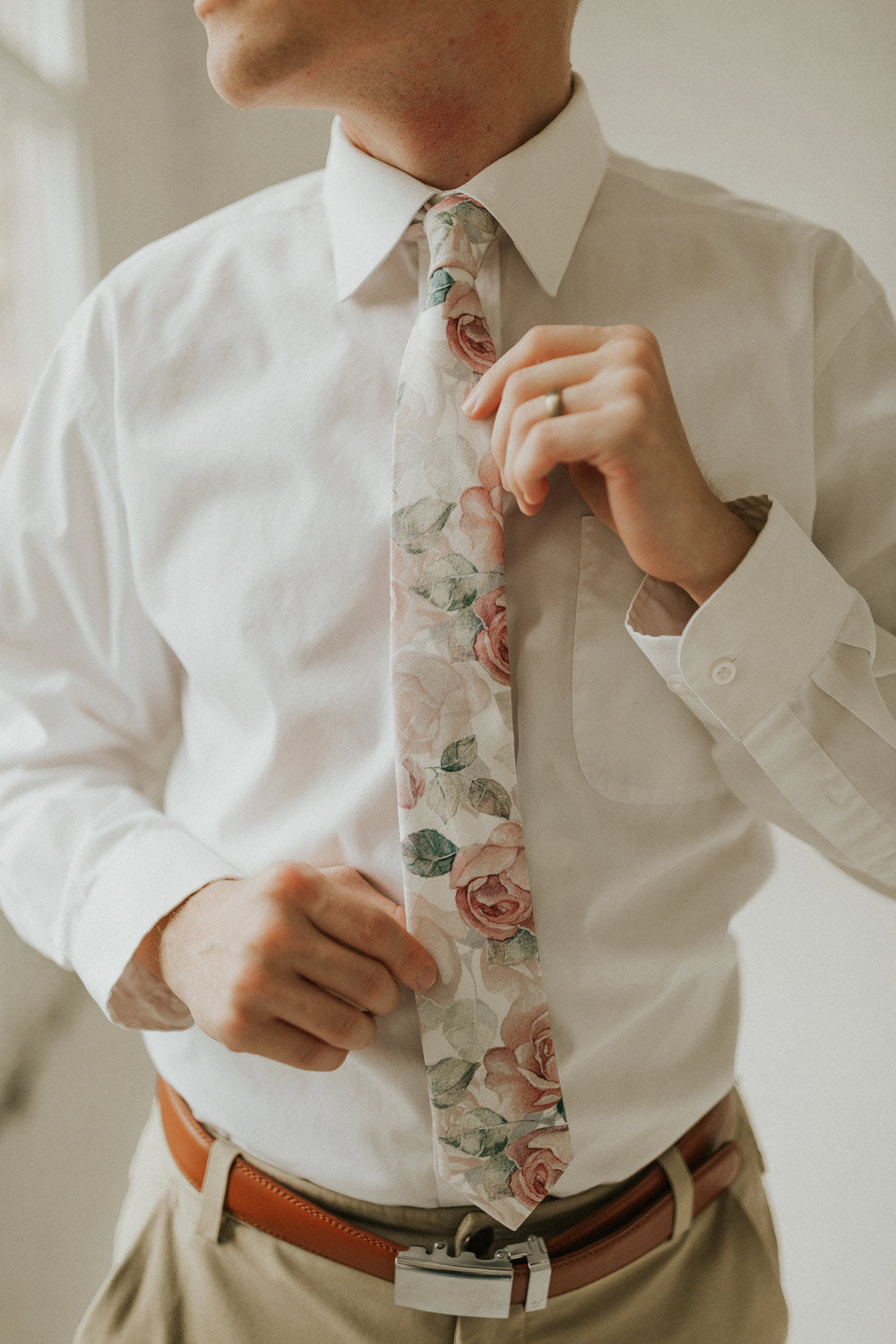 Smitten tie worn with a white shirt, brown belt and khaki pants.