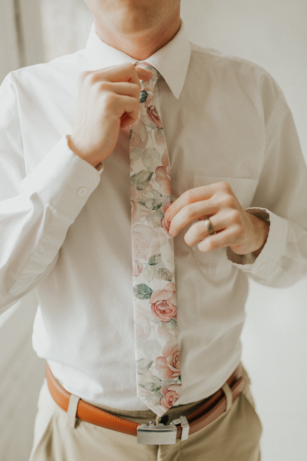 Smitten tie worn with a white shirt, brown belt and khaki pants.