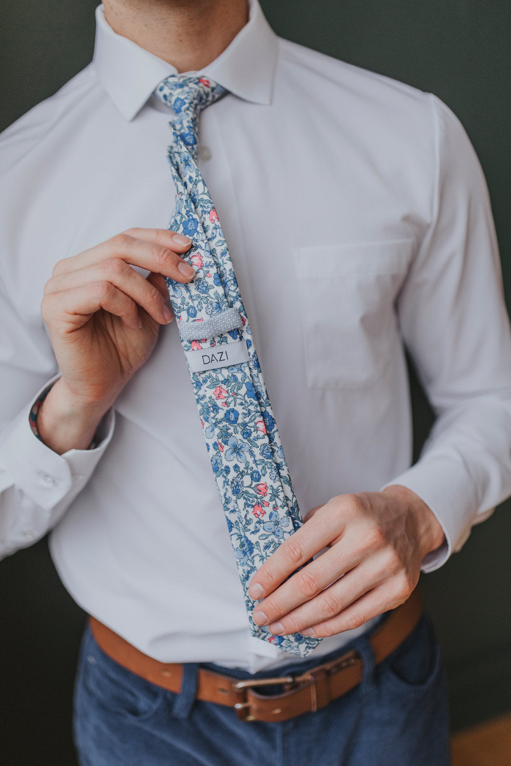 Spring Bloom tie worn with a white shirt, brown belt and navy blue pants.
