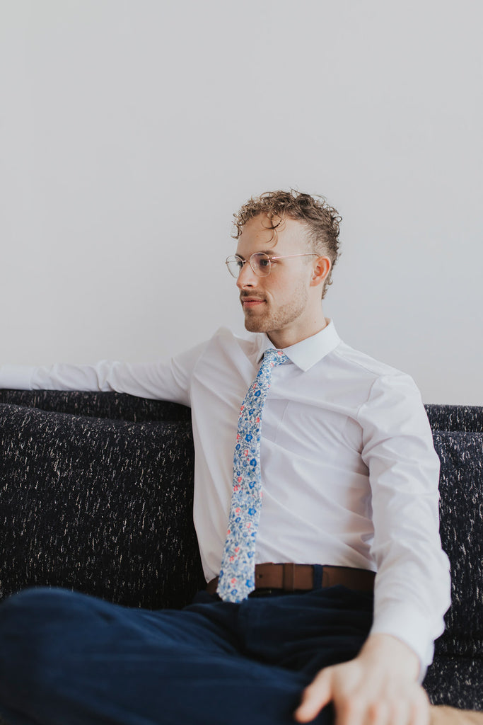 Spring Bloom tie worn with a white shirt, brown belt and navy blue pants.