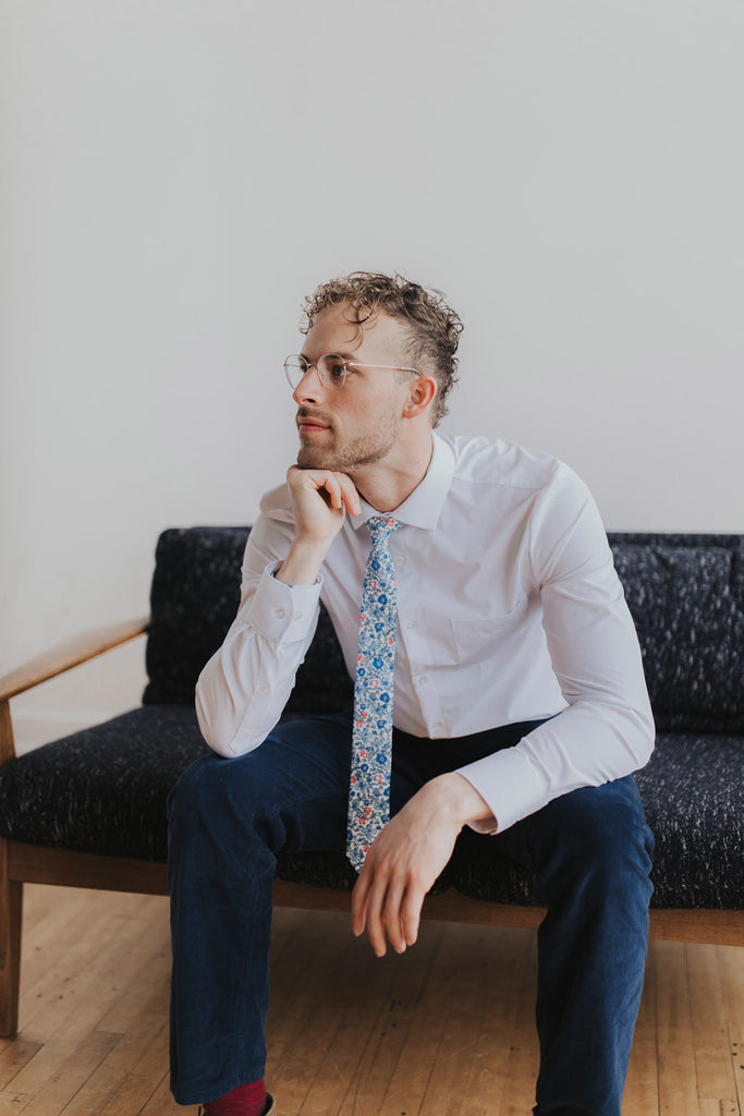Spring Bloom tie worn with a white shirt, brown belt and navy blue pants.