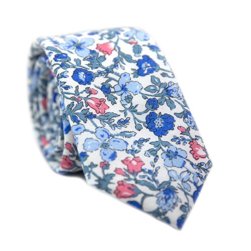 Spring Bloom Skinny Tie. White background with blue and pink flowers and light turquoise vines and leaves.
