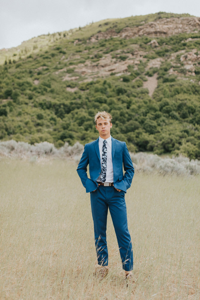 Star Gaze tie worn with a white shirt, brown belt and royal blue suit.