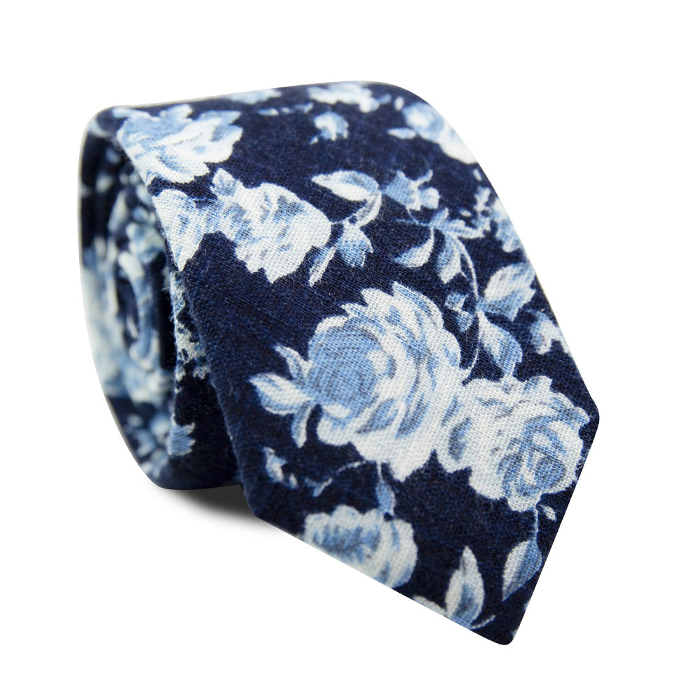 Star Gaze Skinny Tie. Dark navy textured background with medium size white and dusty blue flowers. 