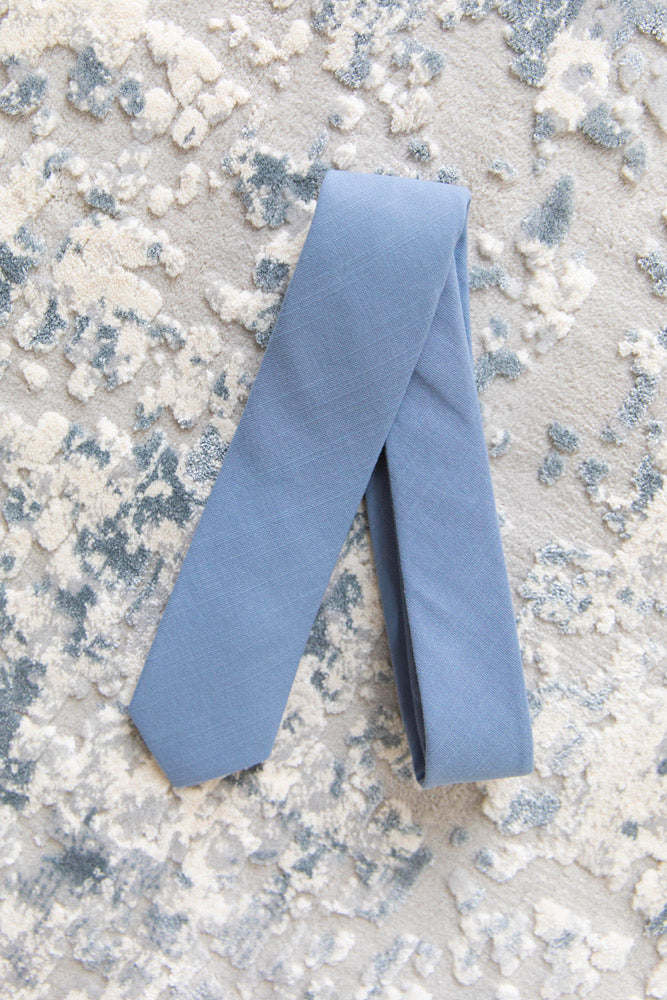 Steel tie laying flat on carpet.