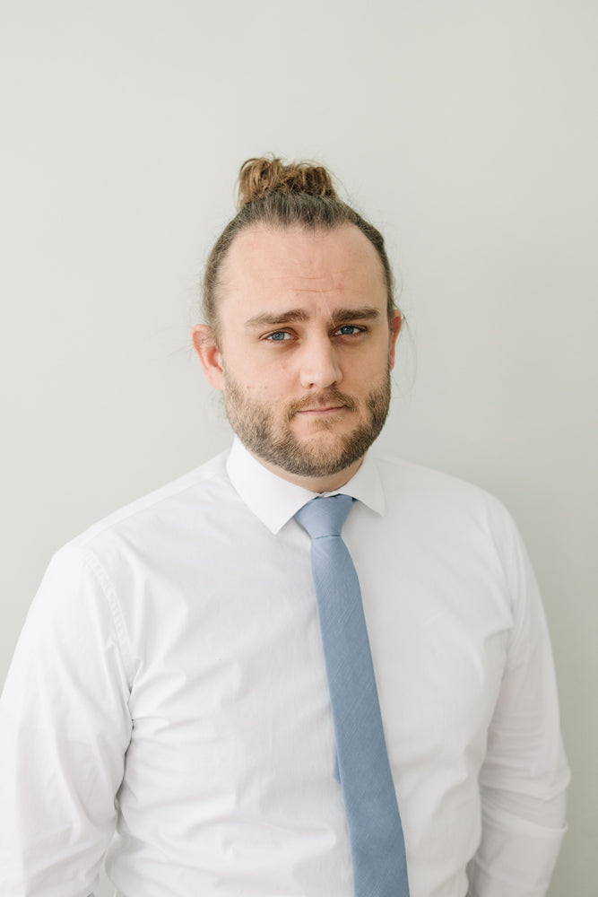 Steel tie worn with a white shirt.