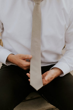 Stone tie worn with a white shirt and black pants. 