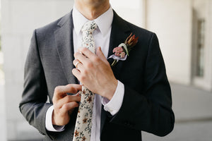 Sugar Blossom tie worn with a white shirt and dark gray suit jacket.
