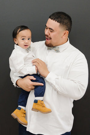 Sunny Meadow pre-tied bow tie worn by a father and son with a white shirt and blue pants.