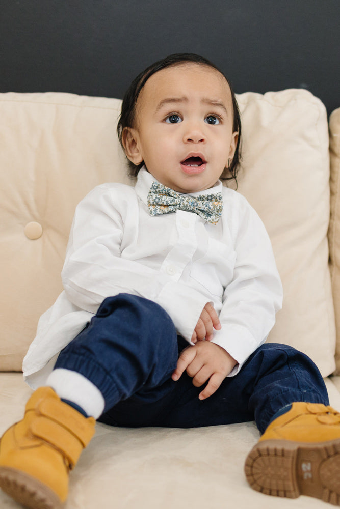 Sunny Meadow pre-tied bow tie worn with a white shirt and blue pants, brown boots.
