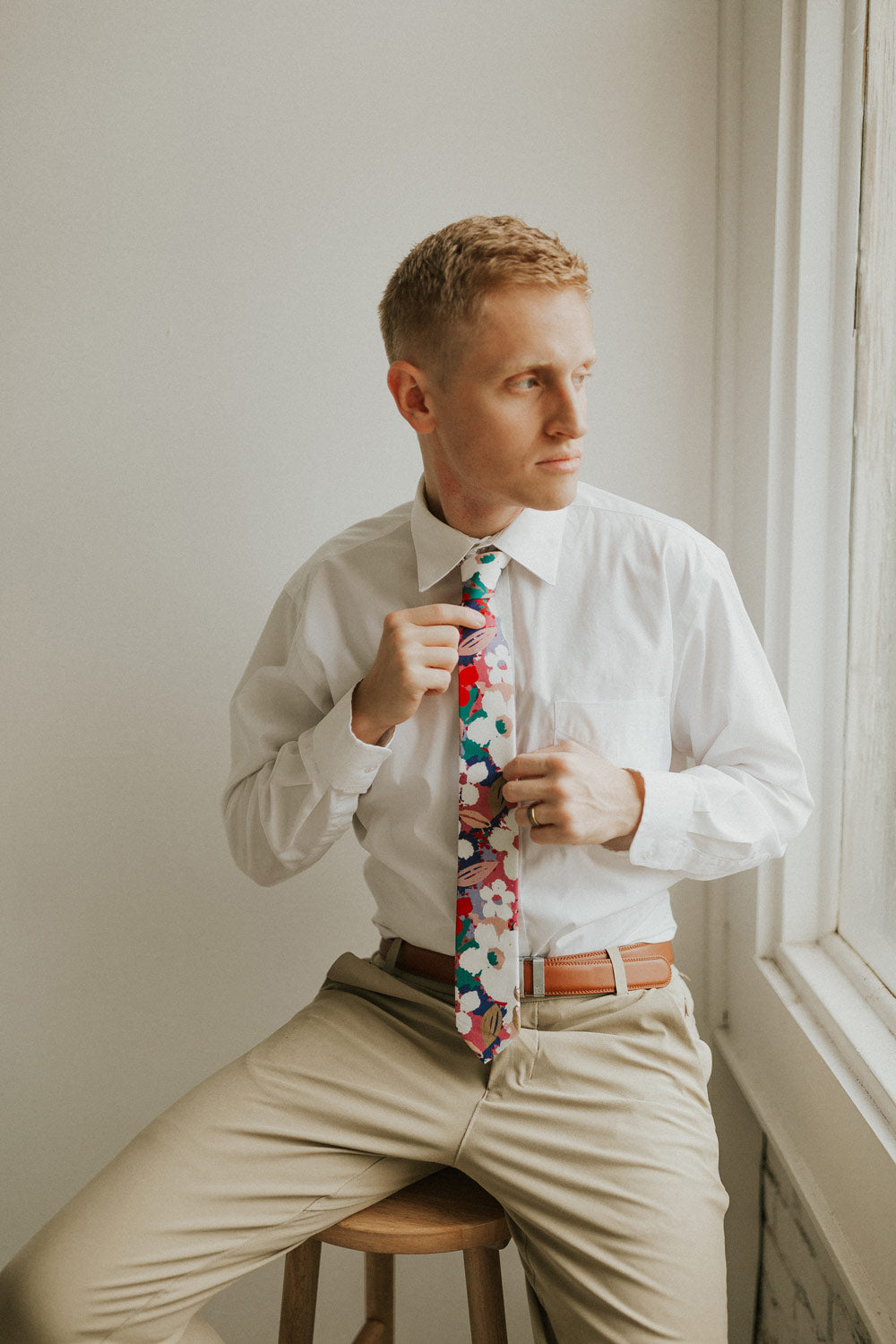 Surfs Up tie worn with a white shirt, brown belt and khaki pants.