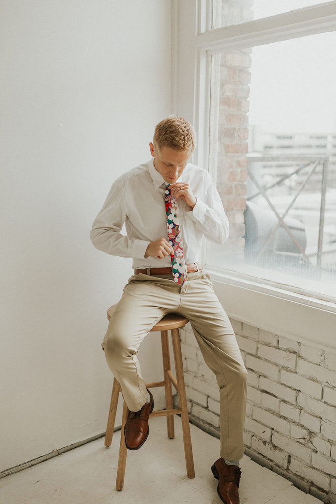 Surfs Up tie worn with a white shirt, brown belt and khaki pants.