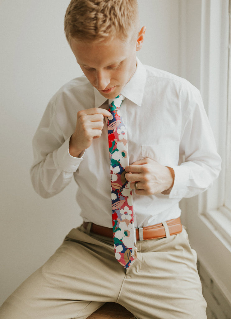 Surfs Up tie worn with a white shirt, brown belt and khaki pants.